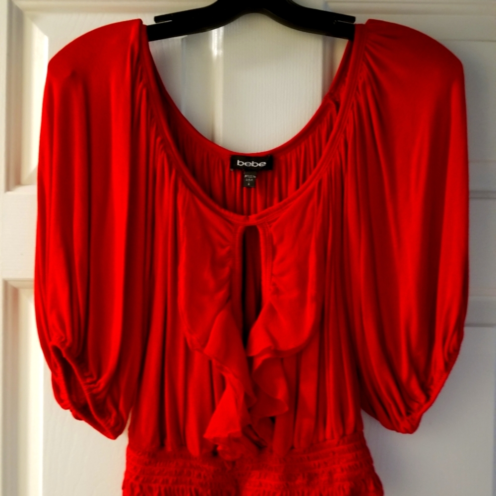 Bebe top with keyhole opening and ruffles